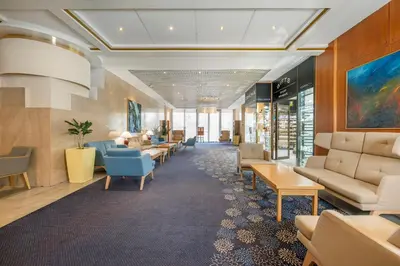 a waiting room with couches and tables at Panorama by Verdi Hotels in Prague