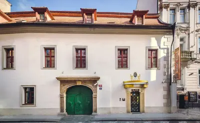 a large white building with a green door at Hotel Elite Prague in Prague