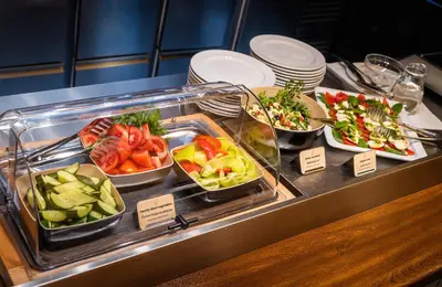 a buffet line with different types of food in trays at Hotel Elite Prague in Prague