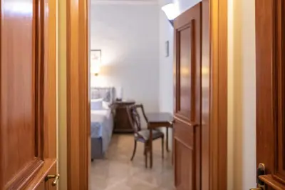 a hallway with a table and a chair in a room at Hotel Elite Prague in Prague