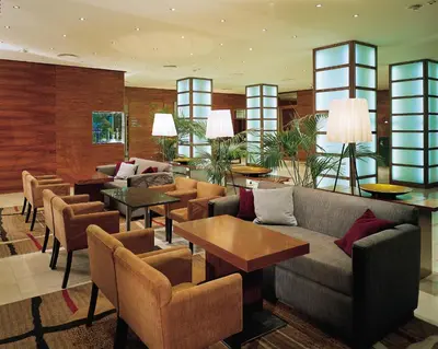 a lobby with a couch and chairs and tables at K+K Hotel Fenix in Prague