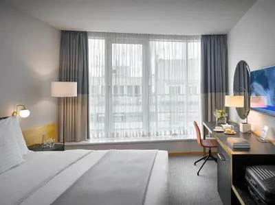 a hotel room with a large bed and a desk at K+K Hotel Fenix in Prague