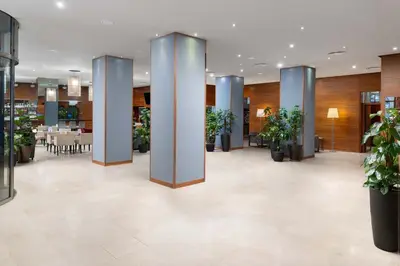 a lobby of a hotel with potted plants at K+K Hotel Fenix in Prague