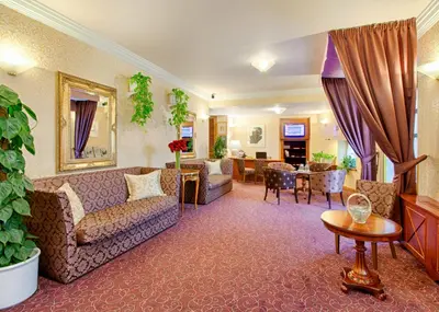 a living room with a couch and a table at Hotel Hoffmeister in Prague