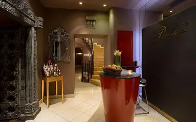a lobby with a stage in the middle of a room at Le Palais Art Hotel Prague in Prague