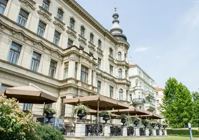 a restaurant with tables and chairs on a roof at Le Palais Art Hotel Prague in Prague