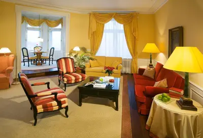 a dining room with a table and two chairs and windows at Le Palais Art Hotel Prague in Prague