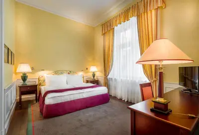 a hallway with a room with a table and a chair at Le Palais Art Hotel Prague in Prague