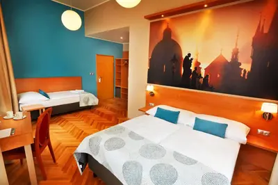 a bedroom with two beds and a painting on the wall at Hotel Adler - Czech Leading Hotels in Prague