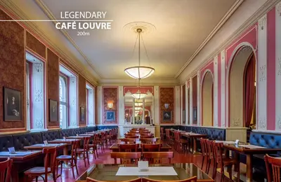 a room with tables and chairs in a restaurant at Hotel Adler - Czech Leading Hotels in Prague