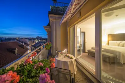 a balcony of a hotel with a bed and a bedroom at Grand Hotel Bohemia in Prague