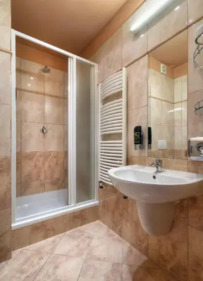 a bathroom with a sink and a shower at Atlantic Hotel in Prague
