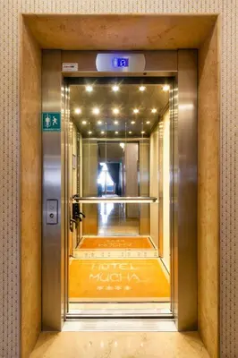 a door to a hotel lobby in a building at Hotel Mucha in Prague