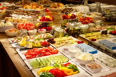 a buffet filled with lots of different types of food at Hotel Mucha in Prague
