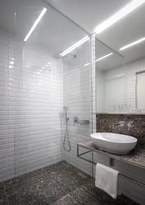 a white bathroom with a sink and a mirror at Hotel Mucha in Prague