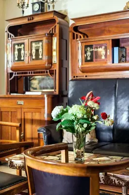 a table with a vase of flowers on it at Hotel Mucha in Prague