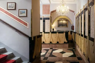 a hallway of a building with a chandelier at The Charles in Prague