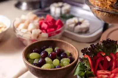 a table topped with bowls of fruit and vegetables at The Charles in Prague
