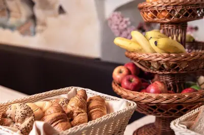 two baskets filled with bread and apples and bananas at The Charles in Prague