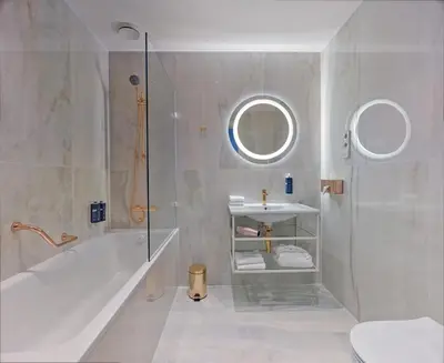 a bathroom with a tub and a sink and a shower at Mamaison Hotel Riverside Prague in Prague