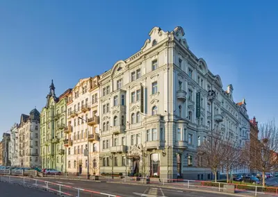 a large white building on the side of a street at Mamaison Hotel Riverside Prague in Prague