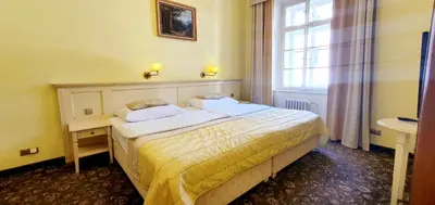 a hotel room with a bed and a window at Hotel Metamorphis in Prague