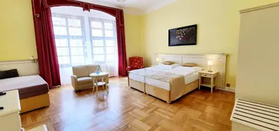 a bedroom with a bed and a large window at Hotel Metamorphis in Prague