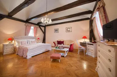 a bedroom with a white bed and a desk at Boutique Hotel Constans in Prague