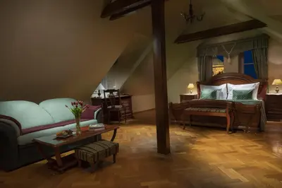 a living room with a bed and a couch and a table at Boutique Hotel Constans in Prague