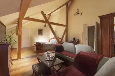 a living room with a couch and a bed at Boutique Hotel Constans in Prague