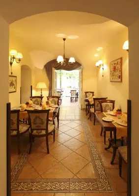 a dining room with wooden tables and chairs at Boutique Hotel Constans in Prague
