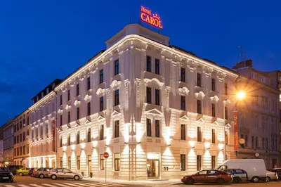 a building with a neon sign on top of it at Hotel Carol in Prague