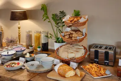 a table filled with bread and baskets of food at Hotel Carol in Prague