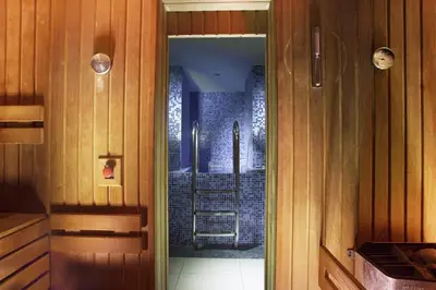 a kitchen with a glass door leading to a shower at Hotel Paris Prague in Prague