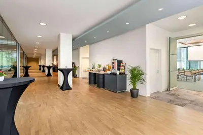 a lobby with tables and chairs in a building at OREA Hotel Andels Praha in Prague