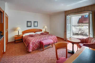 a hotel room with a bed and a balcony at Hotel Savoy Prague in Prague