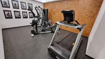 a gym with a treadmill and a elliptical machine at Hotel Savoy Prague in Prague