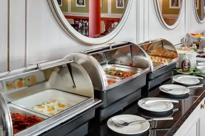 a buffet line with eggs and other breakfast foods at Hotel Savoy Prague in Prague