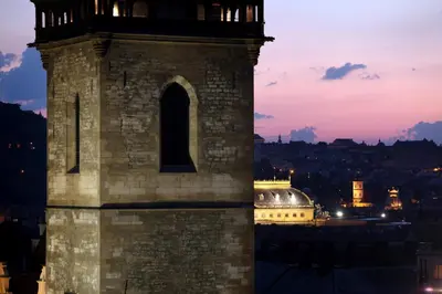 a clock tower with a city in the background at Hotel Suite Home Prague in Prague