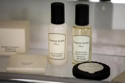 two bottles ofmetics sitting on top of a shelf at Hotel Suite Home Prague in Prague