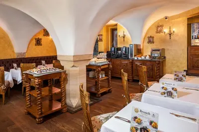 a restaurant with tables and chairs in a room at Iron Gate Hotel & Suites Prague by BHG in Prague