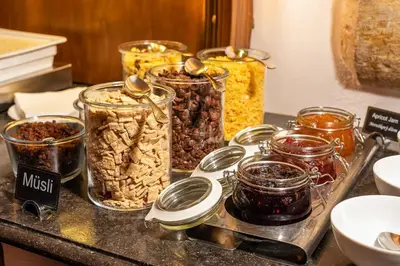 a group of jars of nuts on a counter at Iron Gate Hotel & Suites Prague by BHG in Prague