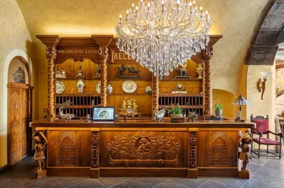a large room with a chandelier and a wooden desk at Iron Gate Hotel & Suites Prague by BHG in Prague