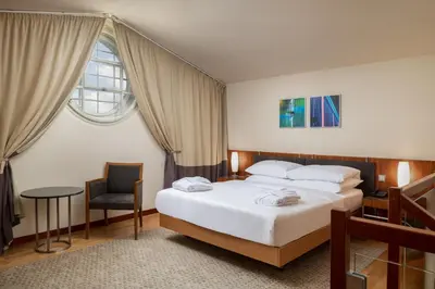 a hotel room with a bed and a chair at K+K Hotel Central in Prague