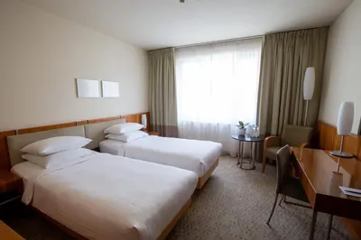 a hotel room with two beds and a desk at K+K Hotel Central in Prague