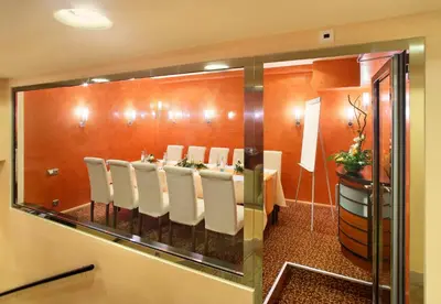 a conference room with a long table with white chairs at Adria Hotel Prague in Prague