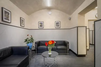 a lobby with two couches and a table with flowers at Hotel White Lion in Prague