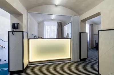 a lobby with a large yellow wall in a room at Hotel White Lion in Prague