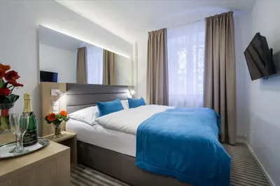 a hotel room with a bed and a window at Hotel White Lion in Prague