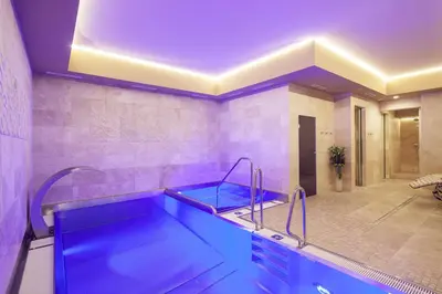 a bathroom with a blue tub in a room at Kosher Hotel King David Prague in Prague